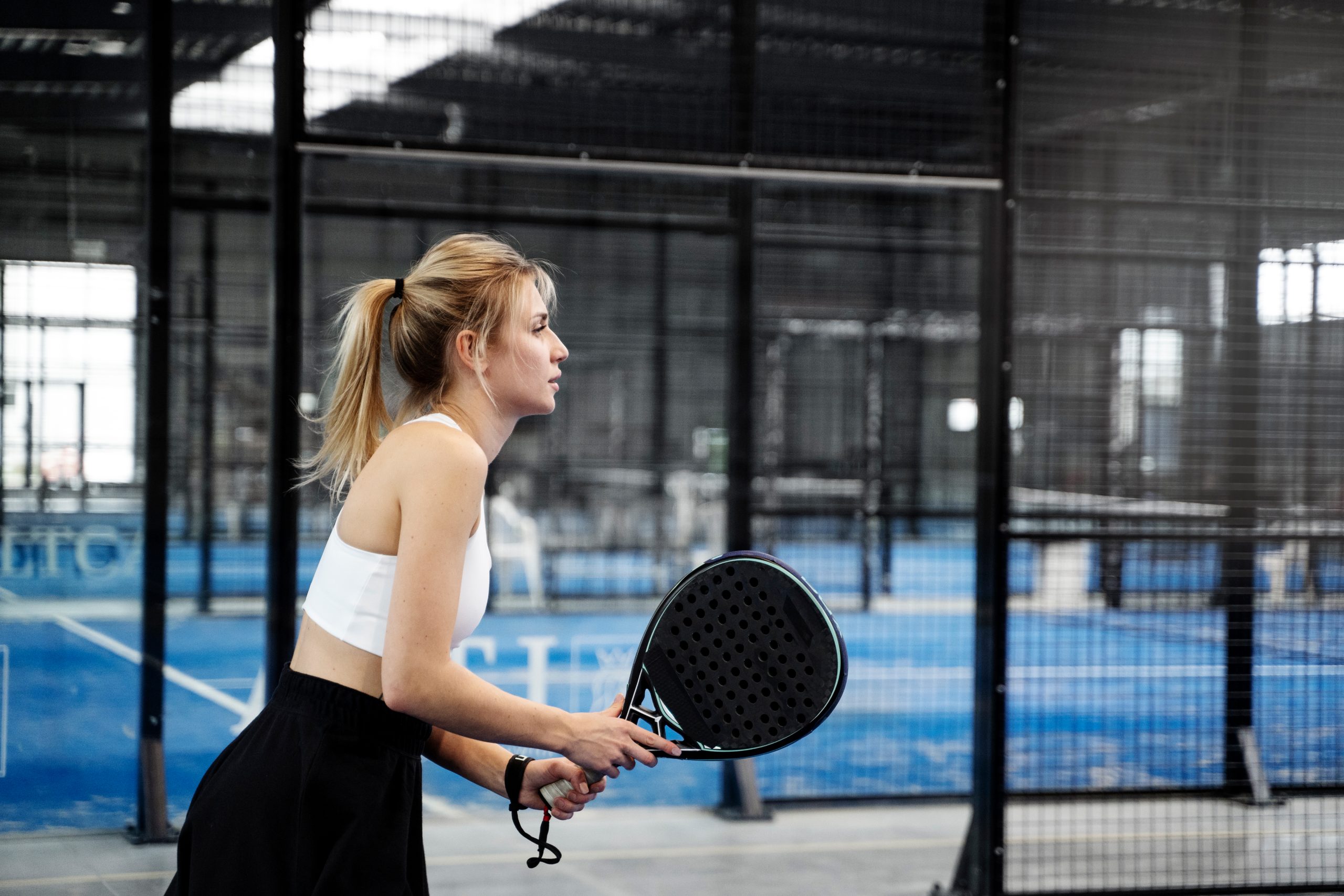 medium shot fit woman playing paddle tennis 1h